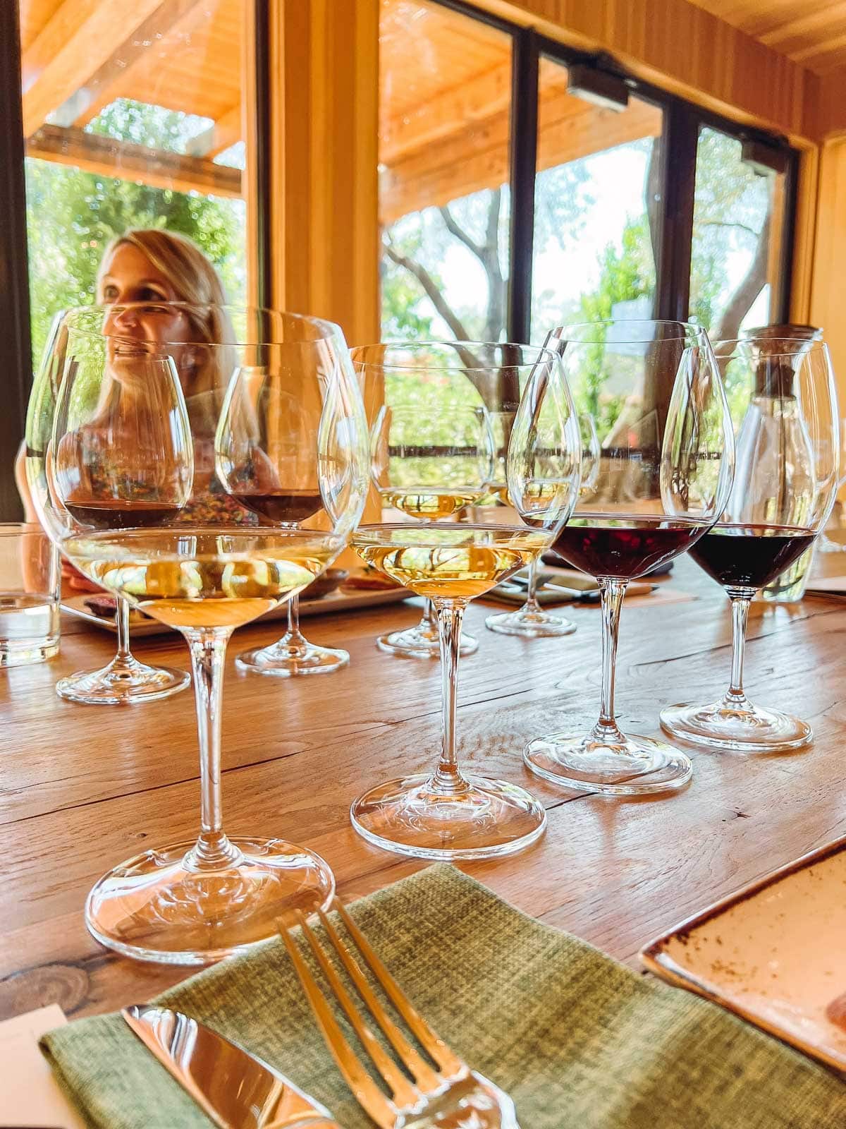 4 wine glasses with small tastings of wine in each.