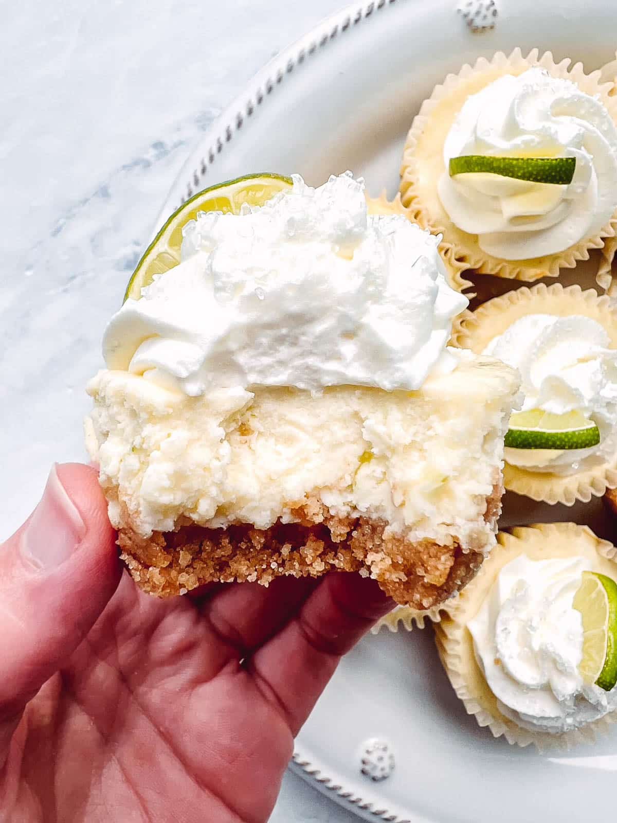 mini margarita cheesecake with bite taken out.