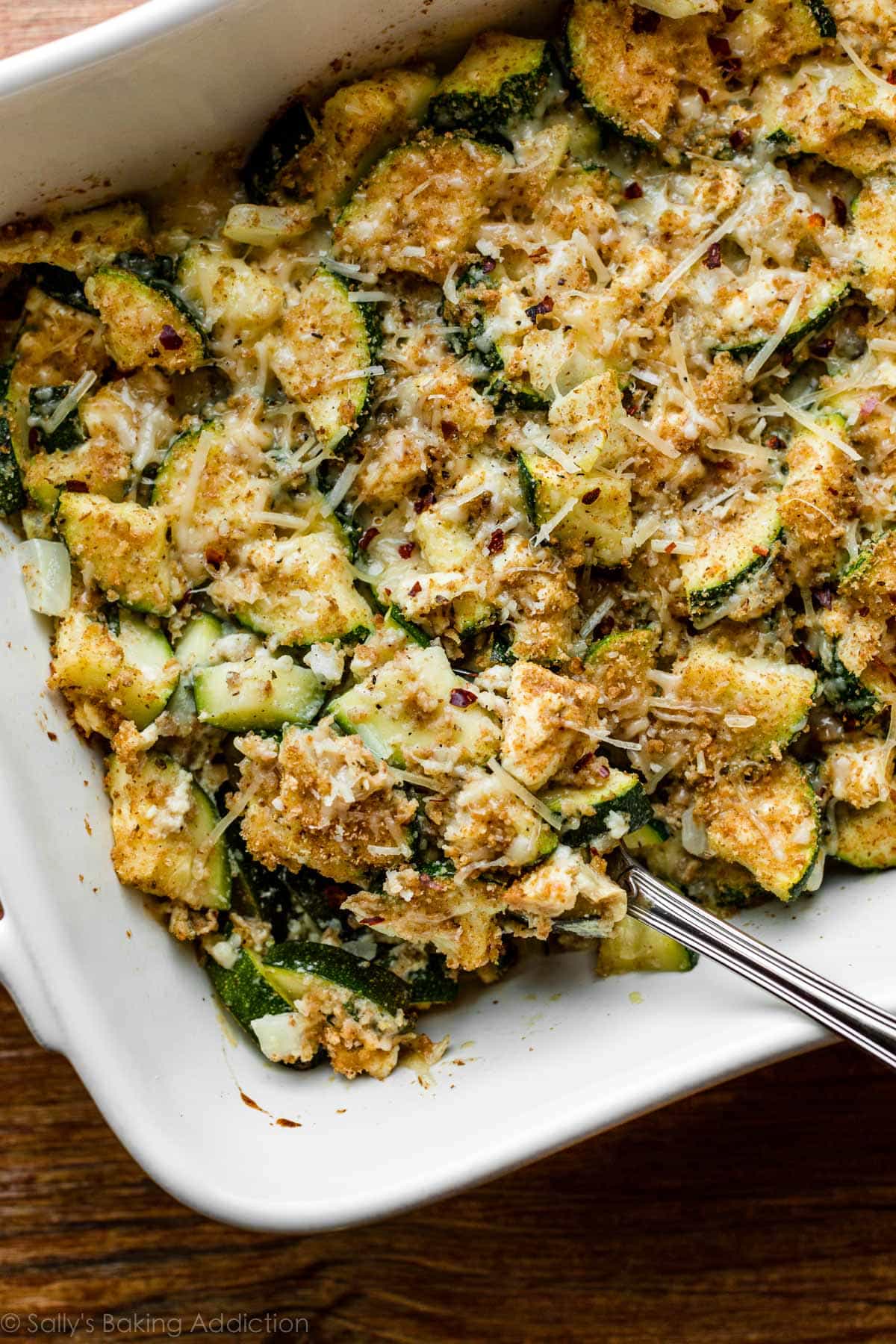 zucchini, herb, and feta bake in white baking dish