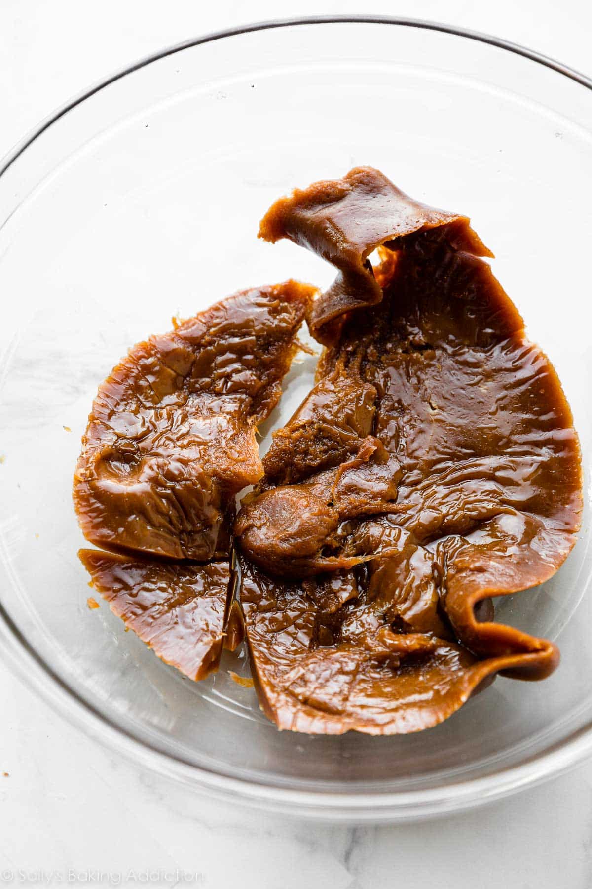 over-cooked caramel mixture in glass bowl.