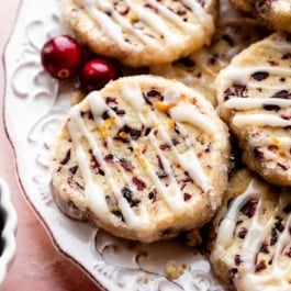 place of cranberry orange cookies with icing drizzled on top of each.