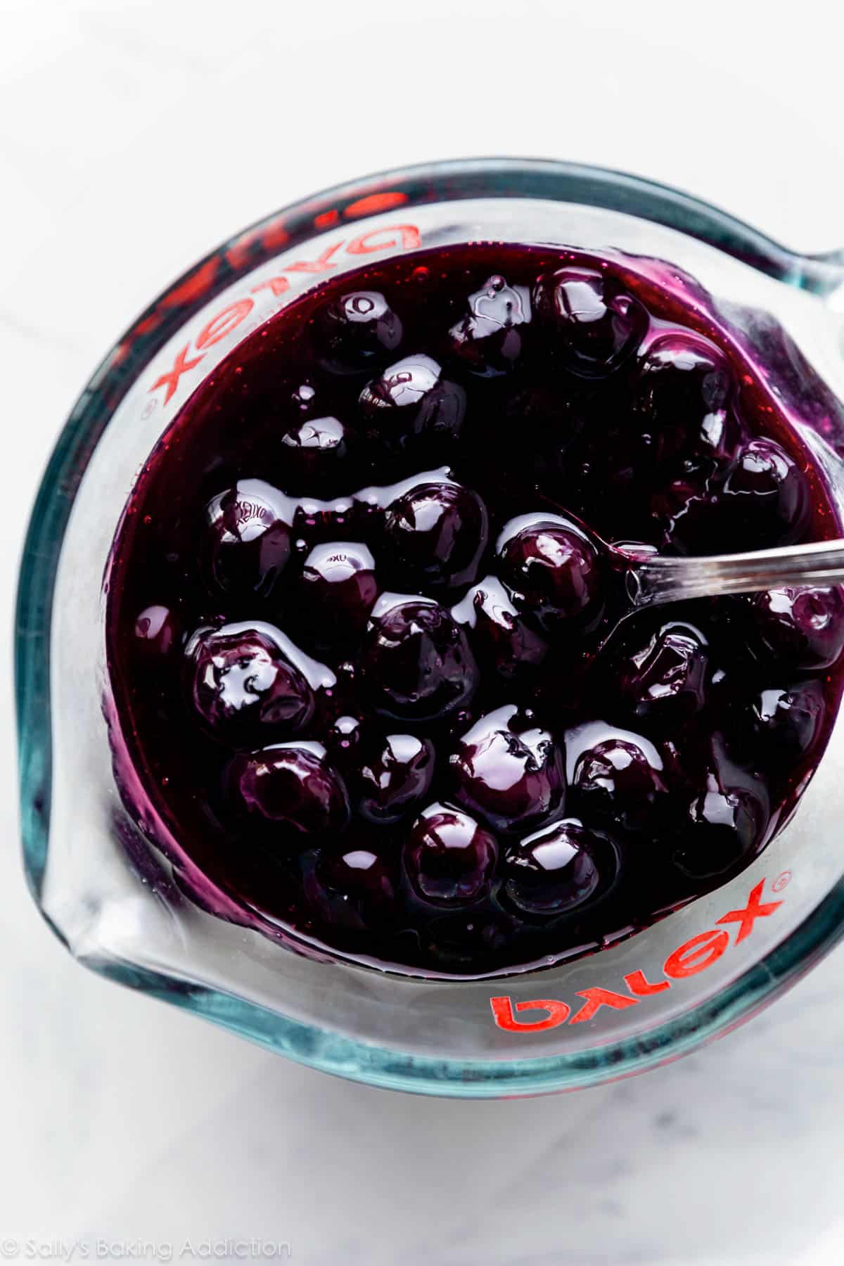 blueberry sauce in Pyrex liquid measuring cup.