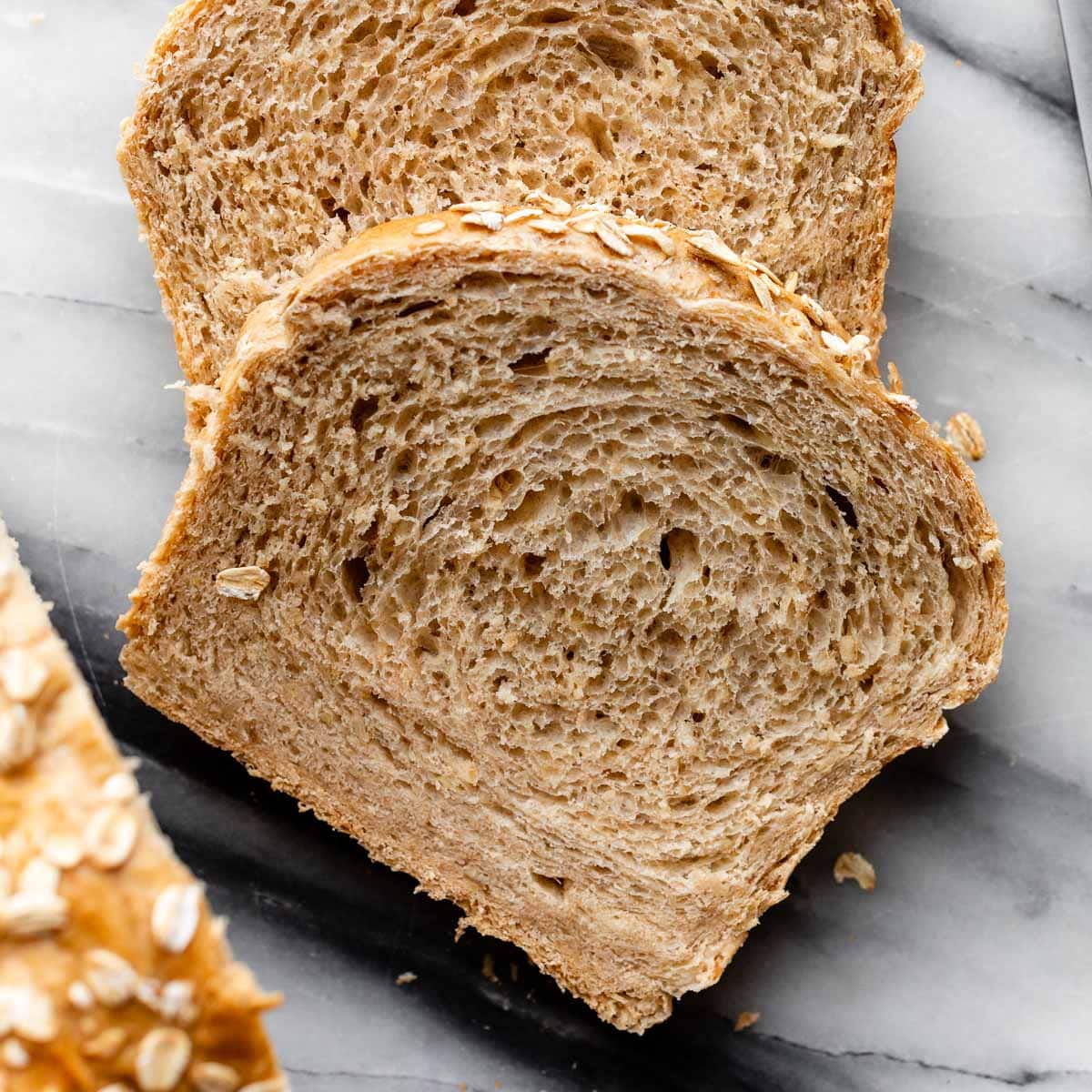 slice of oat bread on marble counter top.