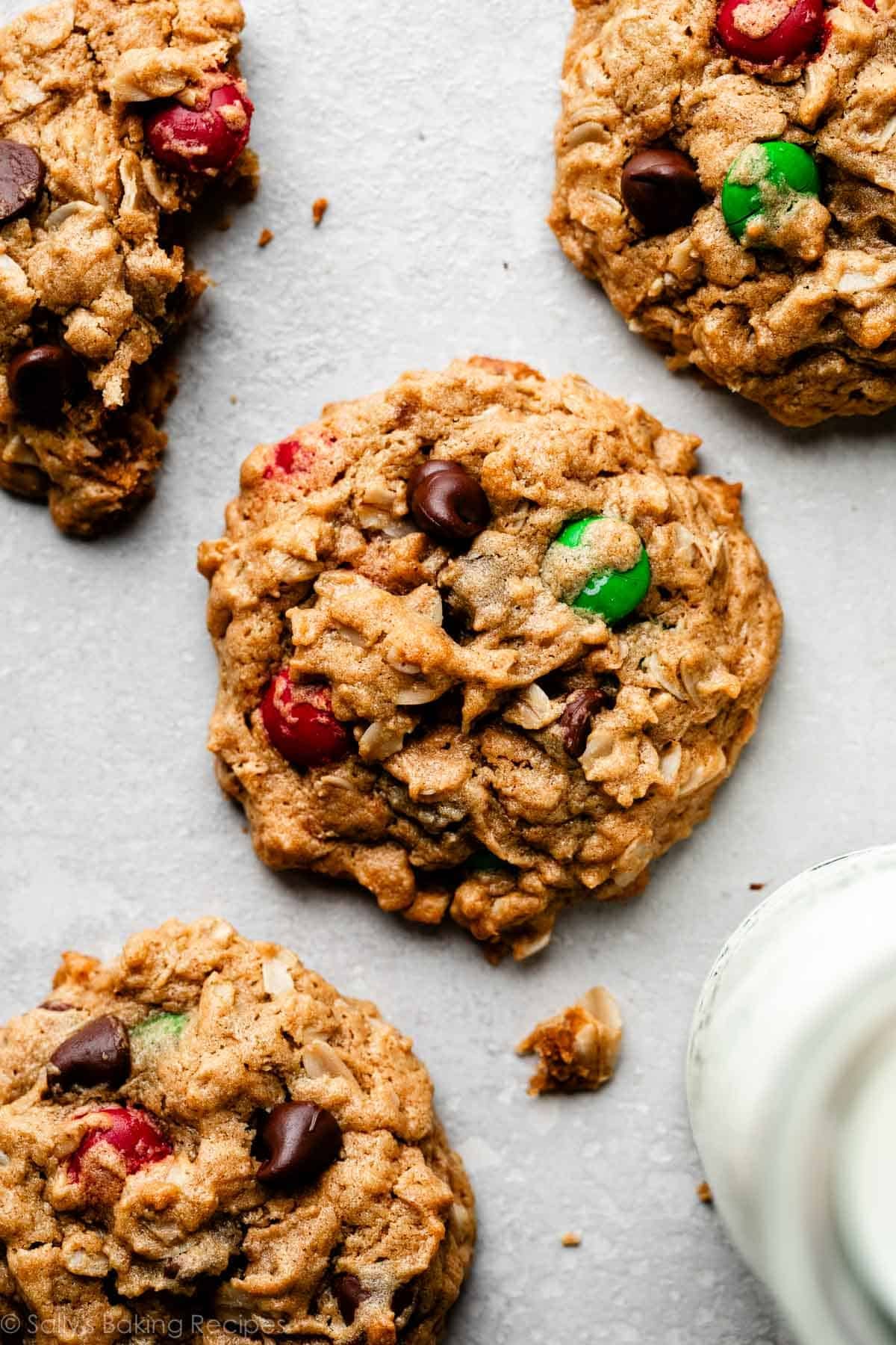close-up overhead photo of flourless peanut butter monster cookies with chocolate chips and red and green M&Ms.