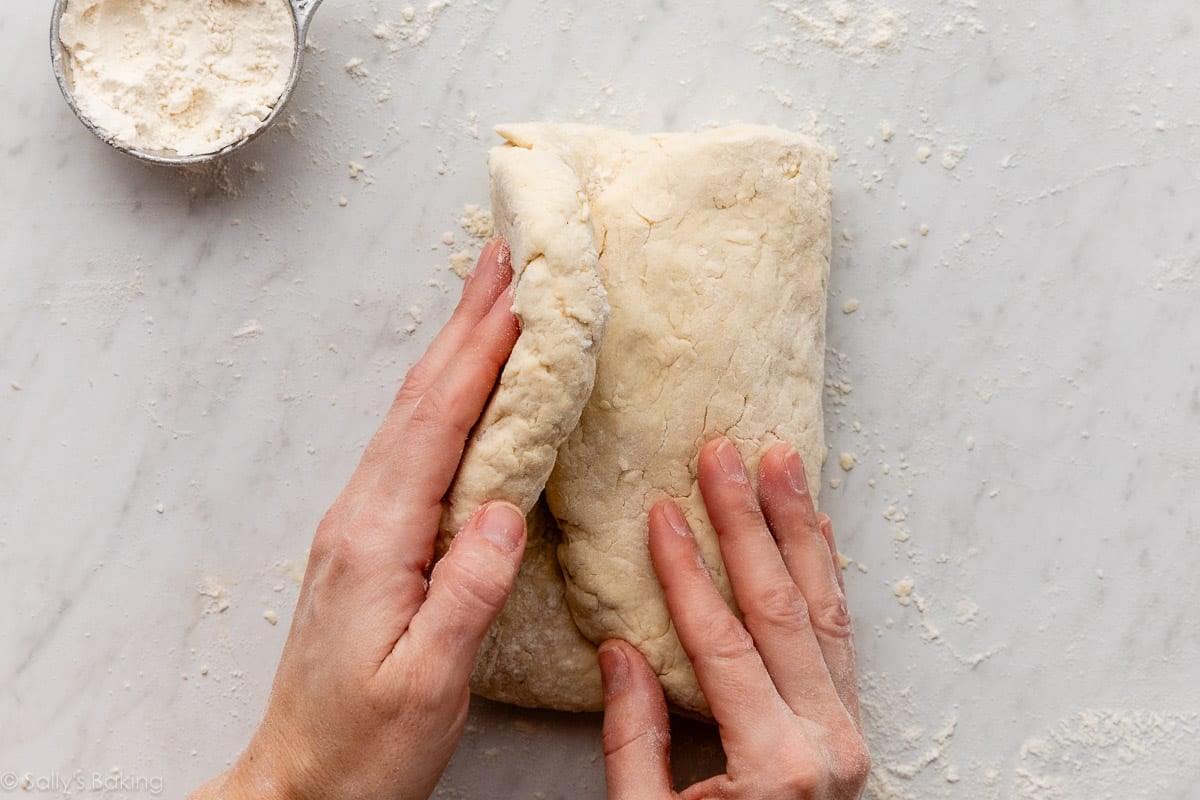 hands folding dough.