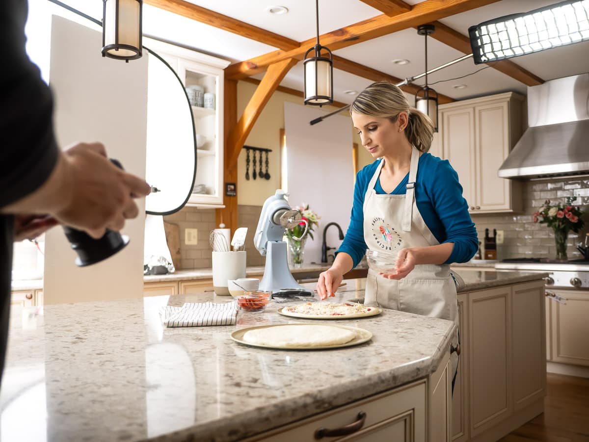 Sally making pizza behind the scenes and camera set.