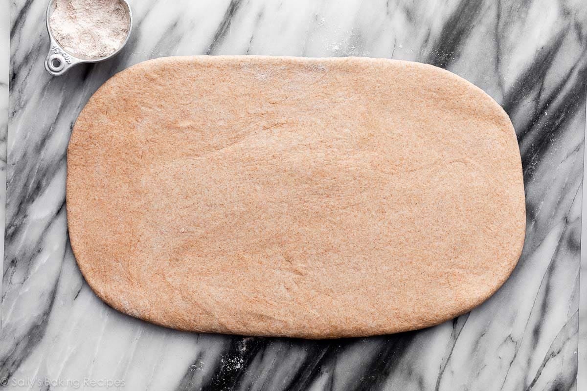 rolled out dough on marble surface.