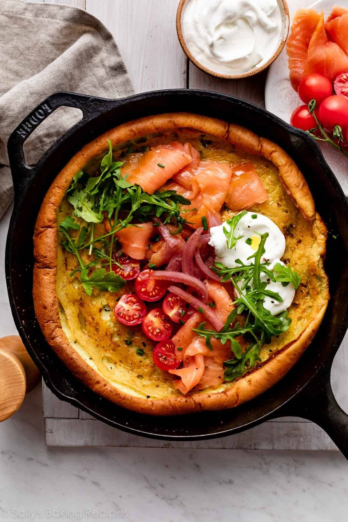 savory dutch baby pancake with tomatoes, sour cream, arugula, smoked salmon, and chives.