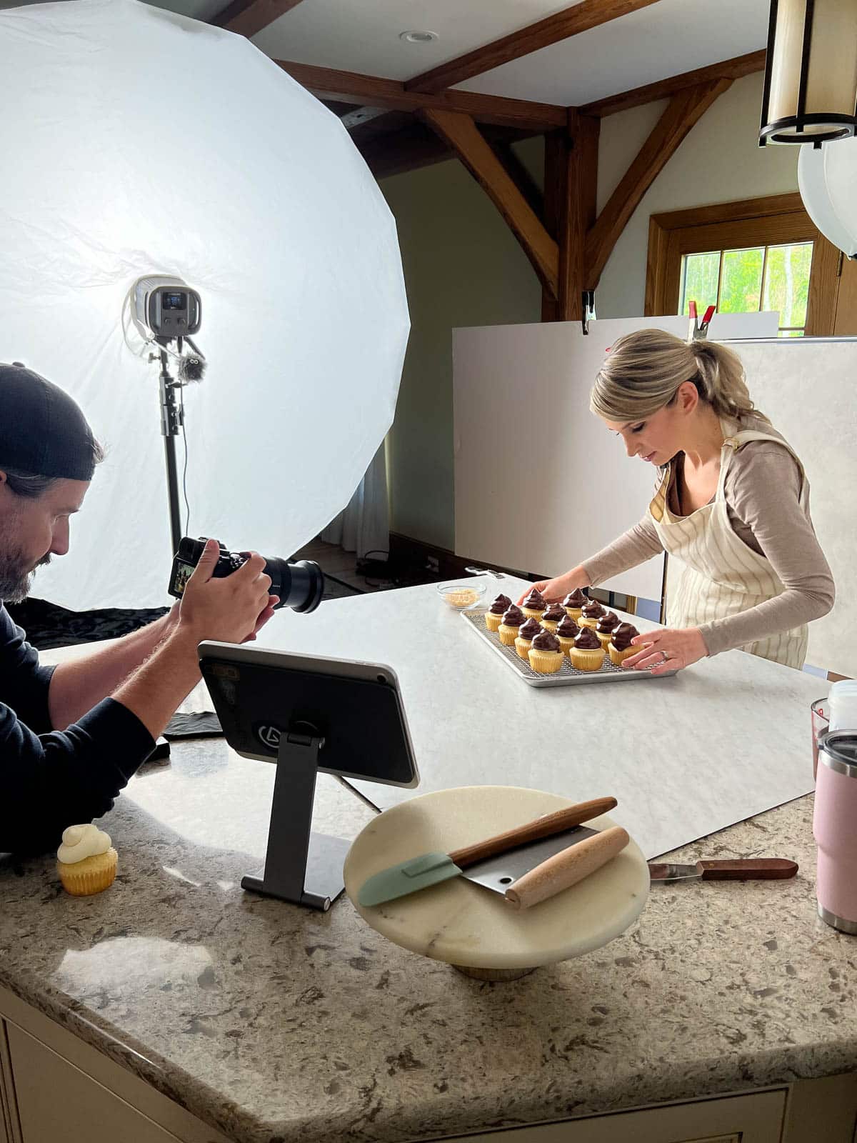 behind the scenes photo of Sally with chocolate-topped cupcakes.