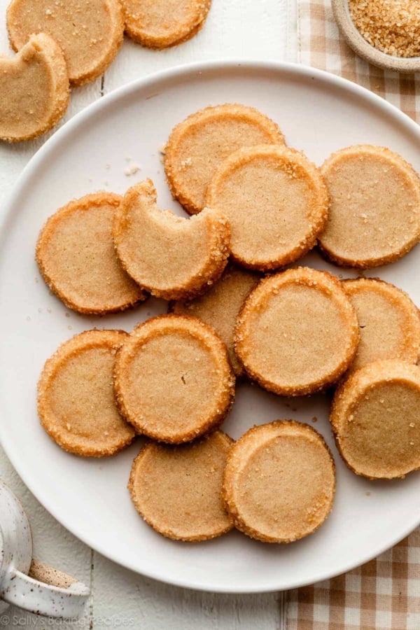 plate of brown sugar shortbread round cookies on white plate.