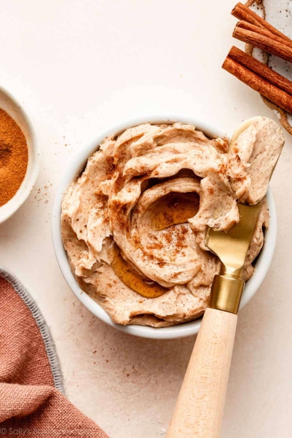 cinnamon butter in white dish with gold butter knife.