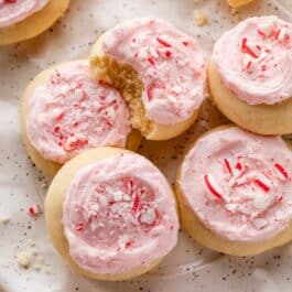 close-up of frosted peppermint meltaway cookies with one with bite taken out.