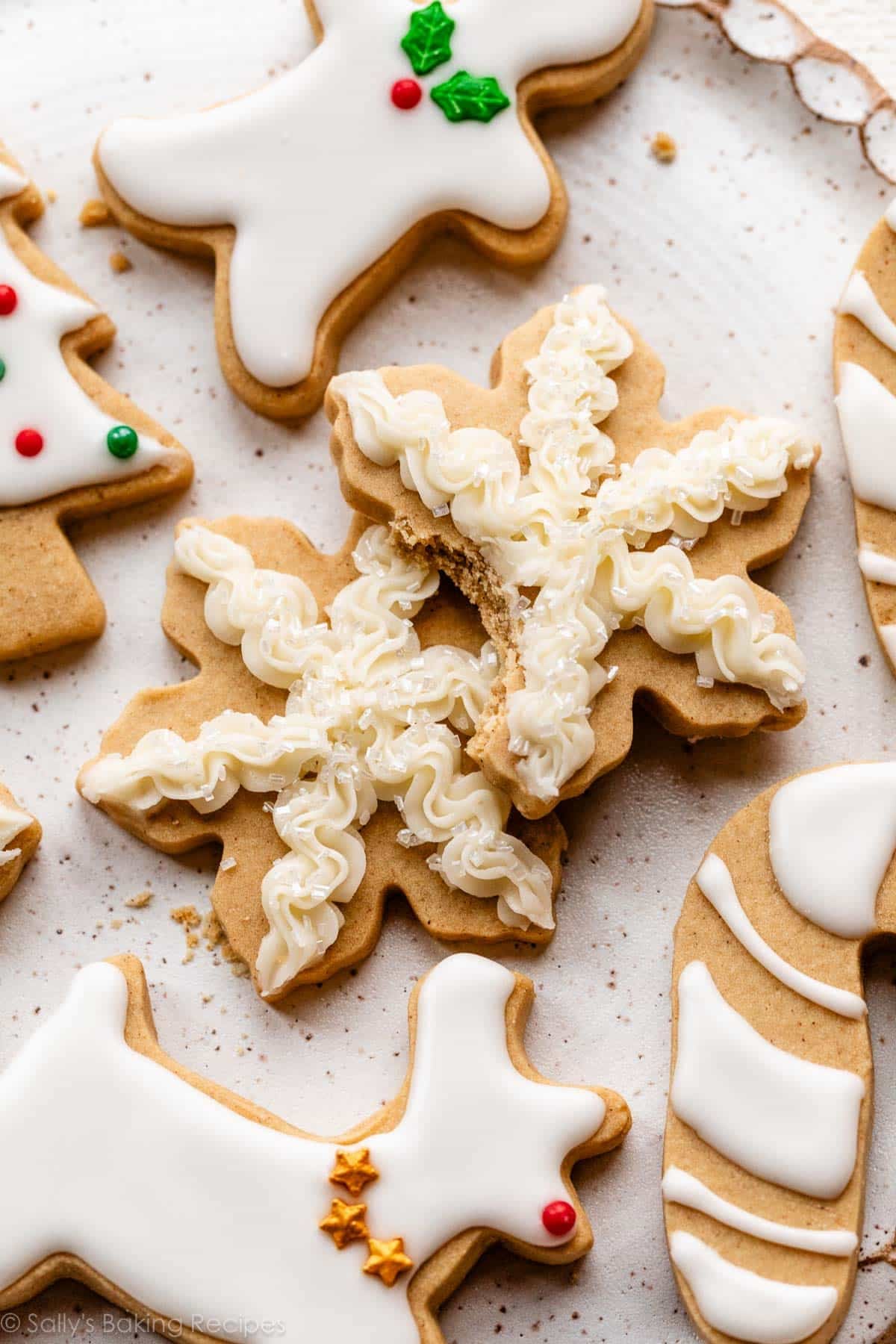 brown sugar snowflake-shaped cookies with buttercream on top.