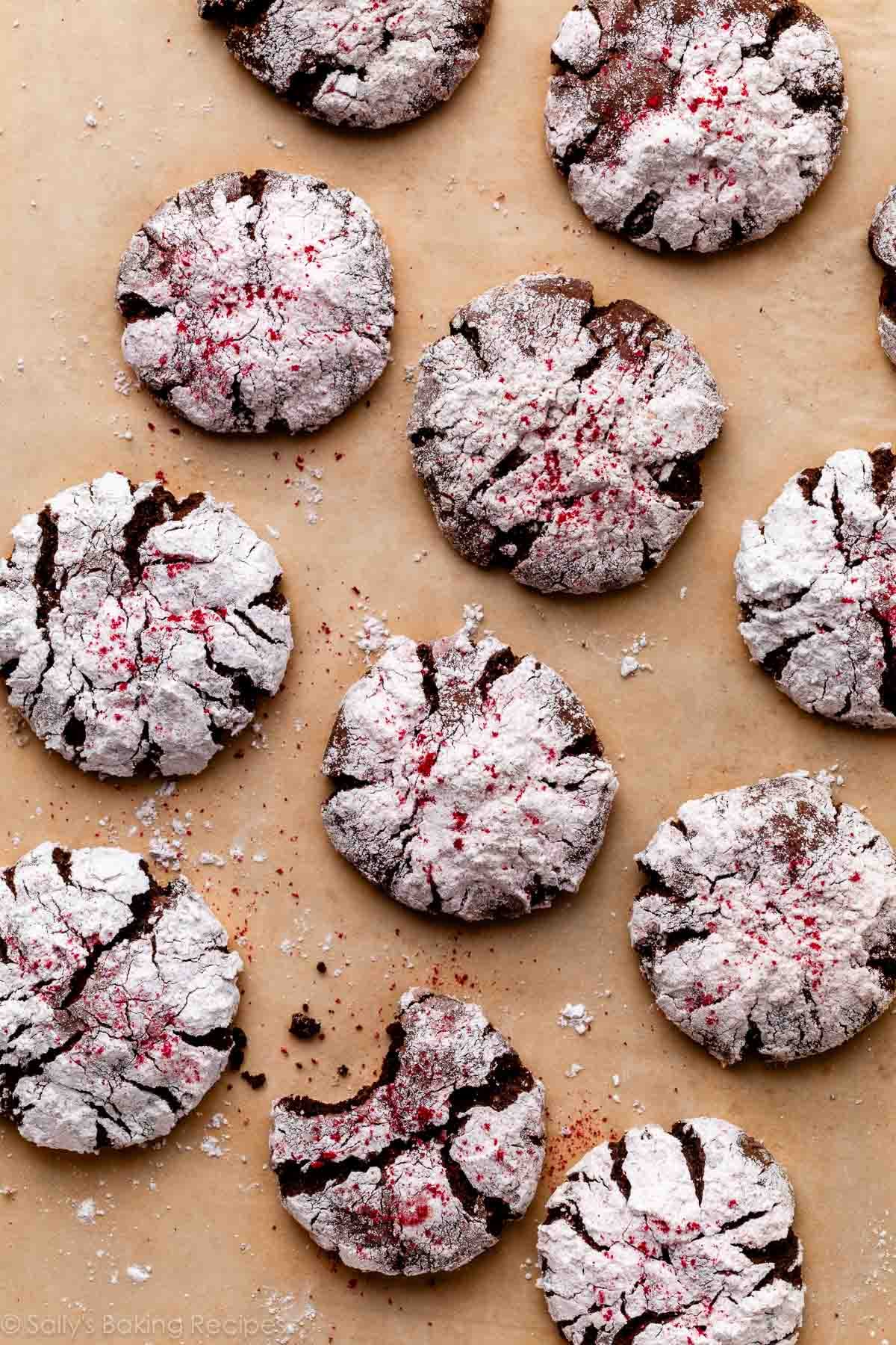 raspberry chocolate crinkle cookies on brown parchment paper.