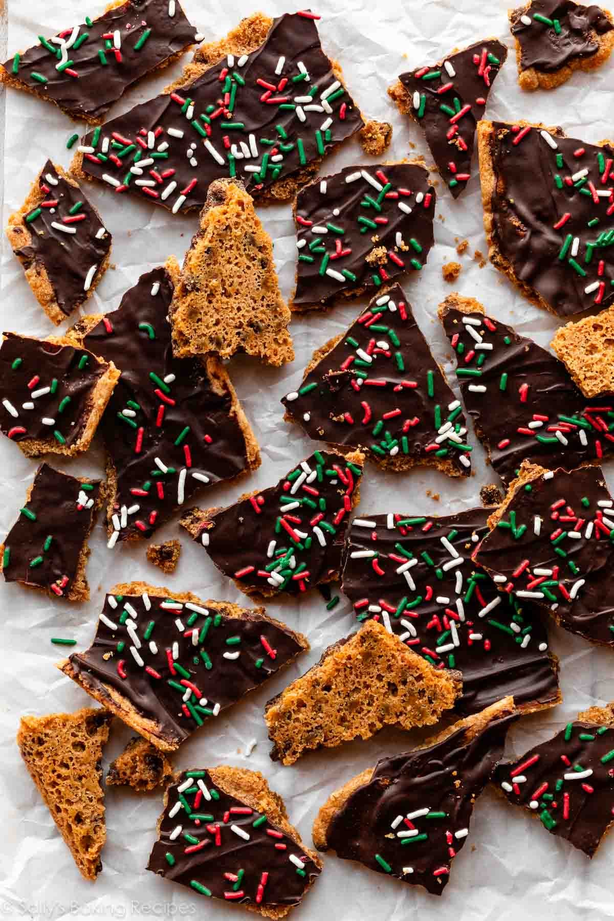 cookie bark broken into pieces with chocolate and Christmas sprinkles on top.