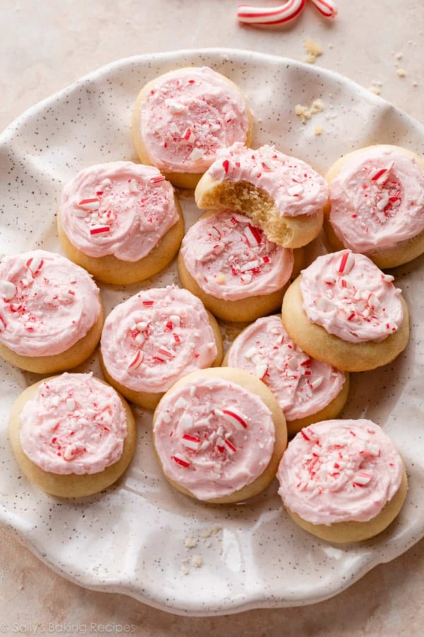 peppermint meltaway cookies with pink frosting and crushed candy canes on top.
