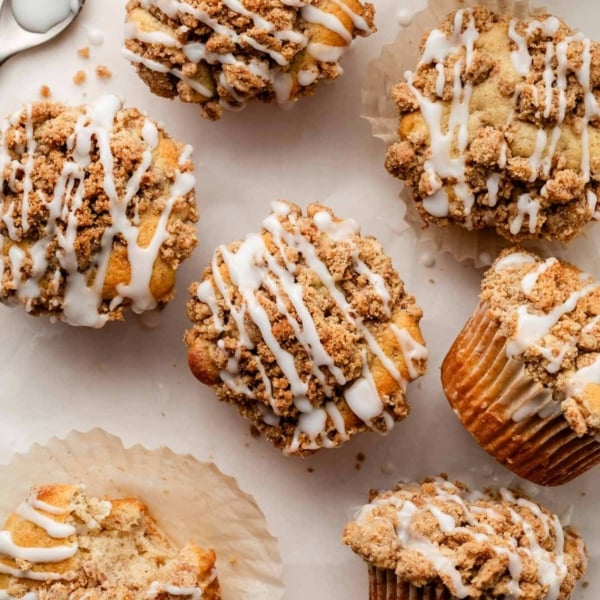 crumb cake muffins with icing on top.