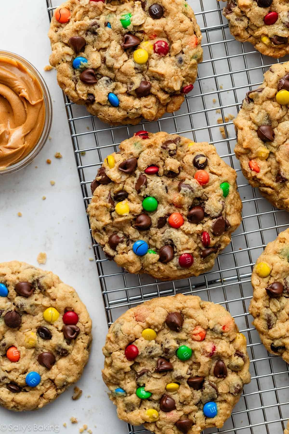 monster cookies with M&Ms on cooling rack.