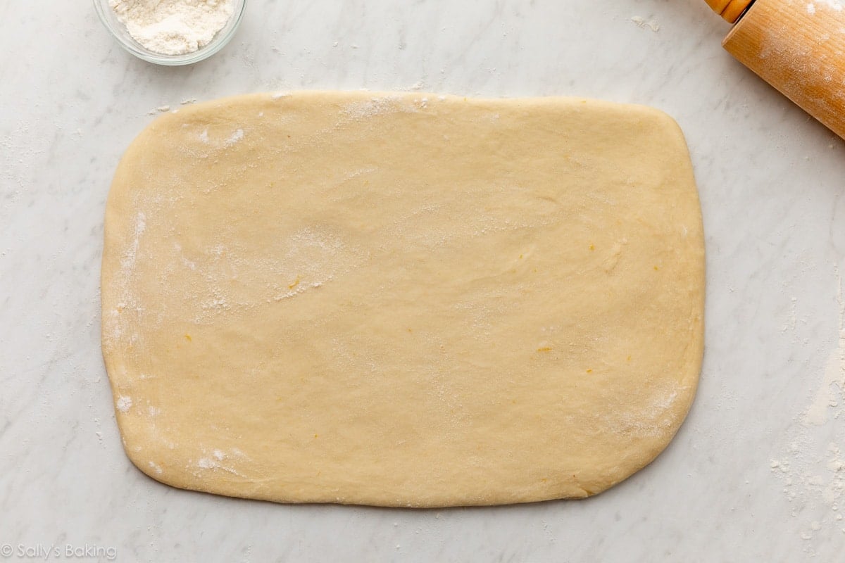 rolled out dough on marble surface.