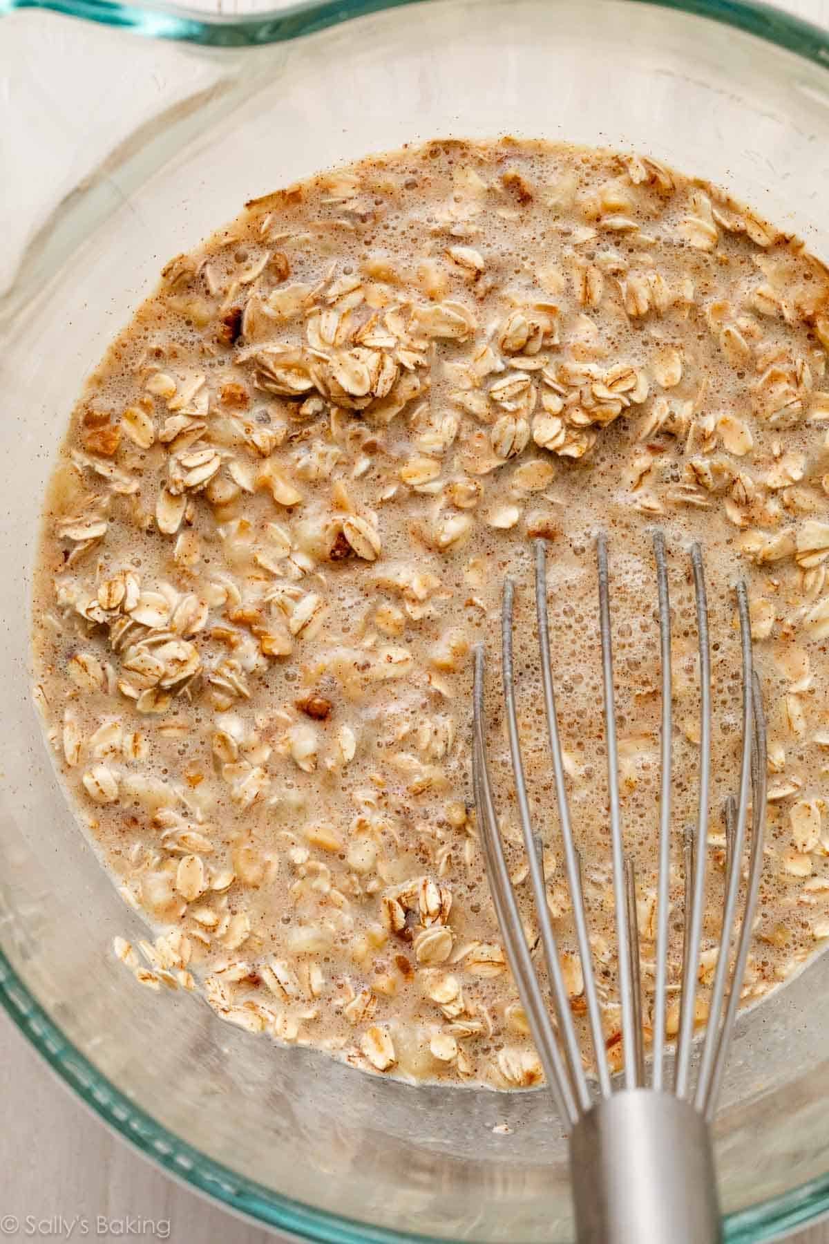 oats and liquid in glass bowl with whisk.