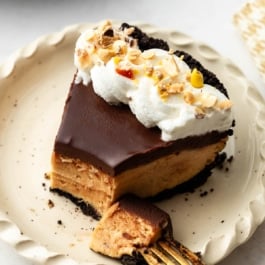 slice of peanut butter pie topped with whipped cream.