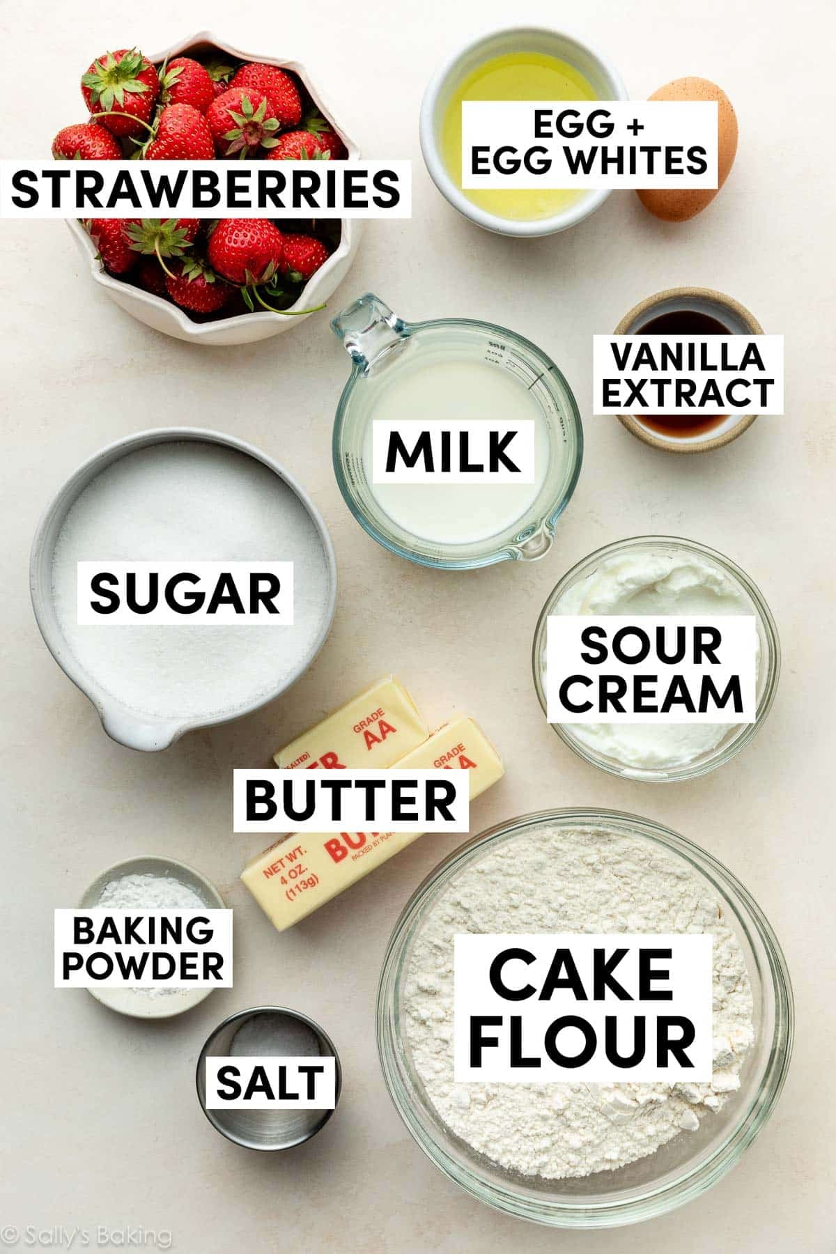 ingredients on surface including egg whites, cake flour, butter, sugar, milk.