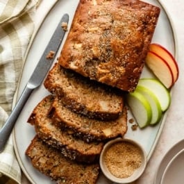 apple zucchini bread cut into slices on platter.