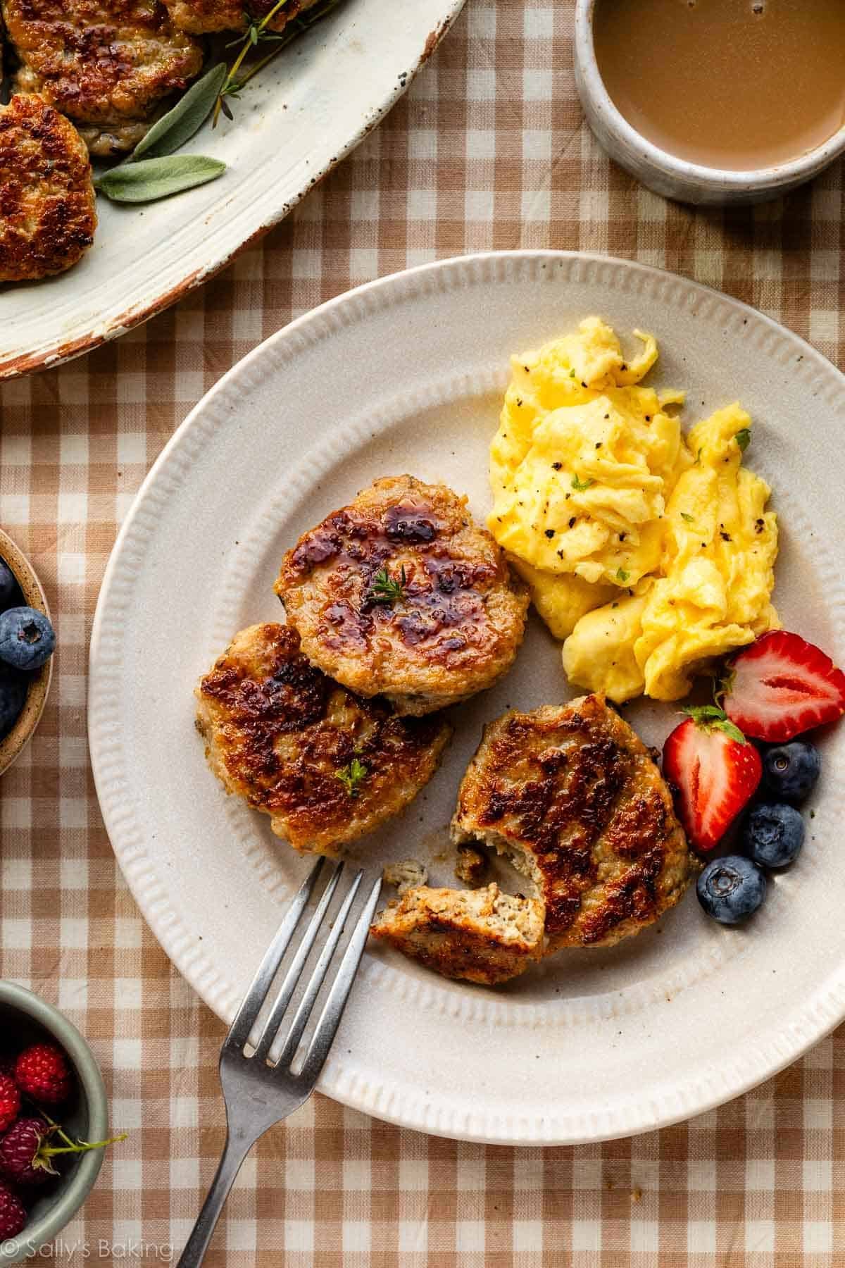 plate with homemade chicken sausage patties, scrambled eggs, and berries.