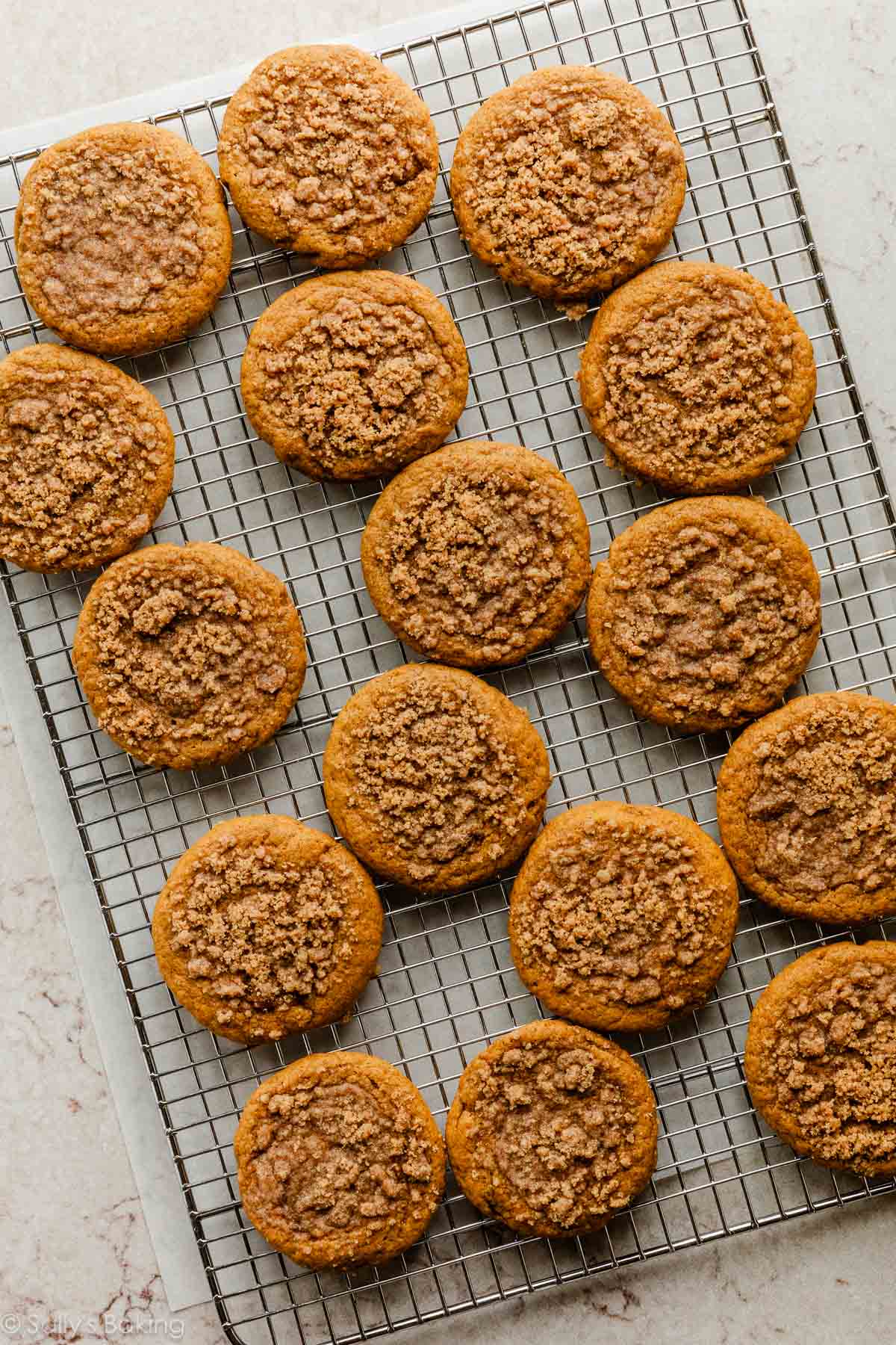 pumpkin cookies with crumb topping on cooling rack.