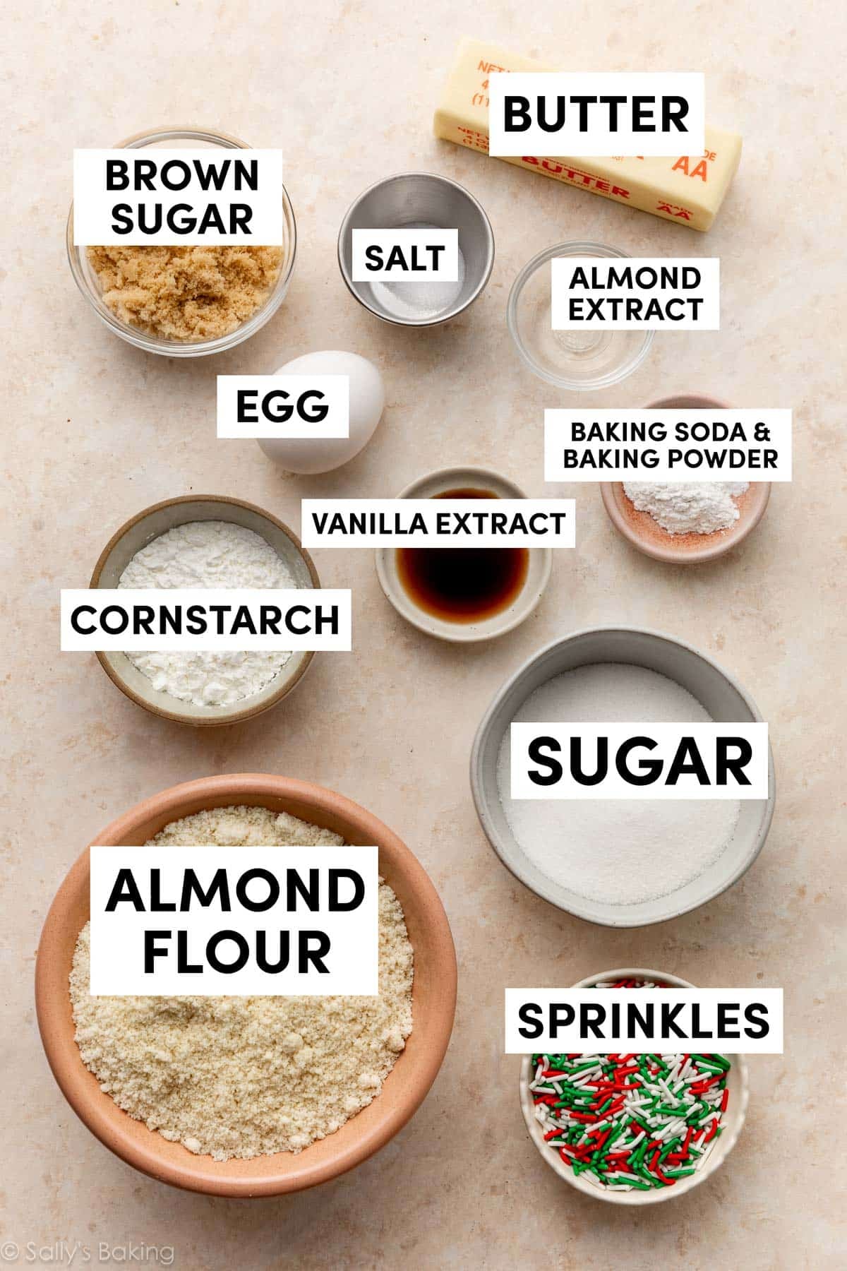 ingredients in bowls including butter, brown sugar, almond flour, sprinkles, cornstarch, and sugar.