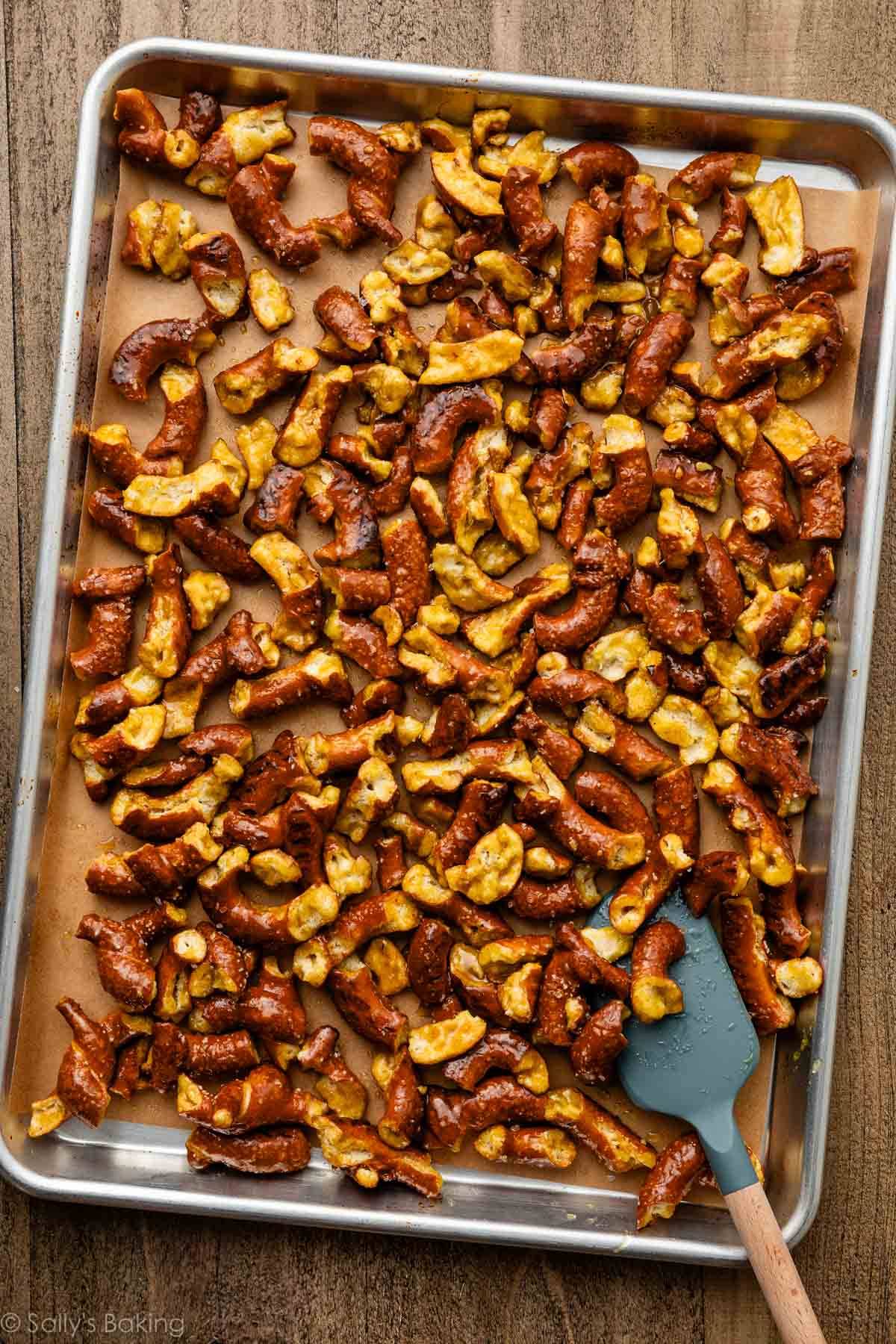 coated pretzels on lined baking sheet.