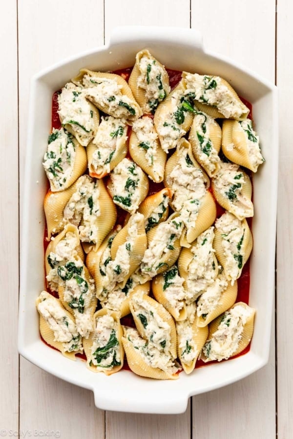 assembled pasta shells in white baking dish.